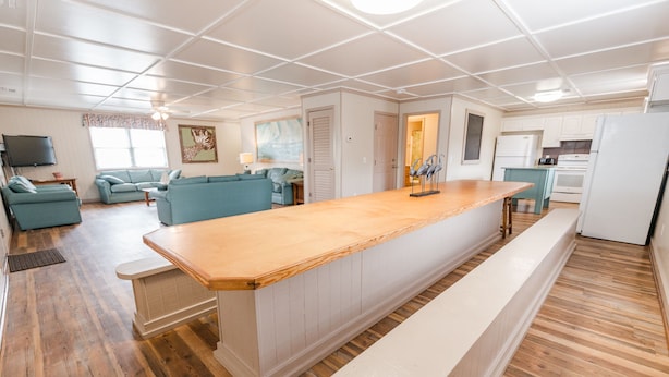 A modern kitchen with a wooden countertop, white cabinets, and a built-in oven. - Short walk from beach, 5 Bedroom/3 Bath Duplex-10-plenty of room for groups (North Myrtle Beach)