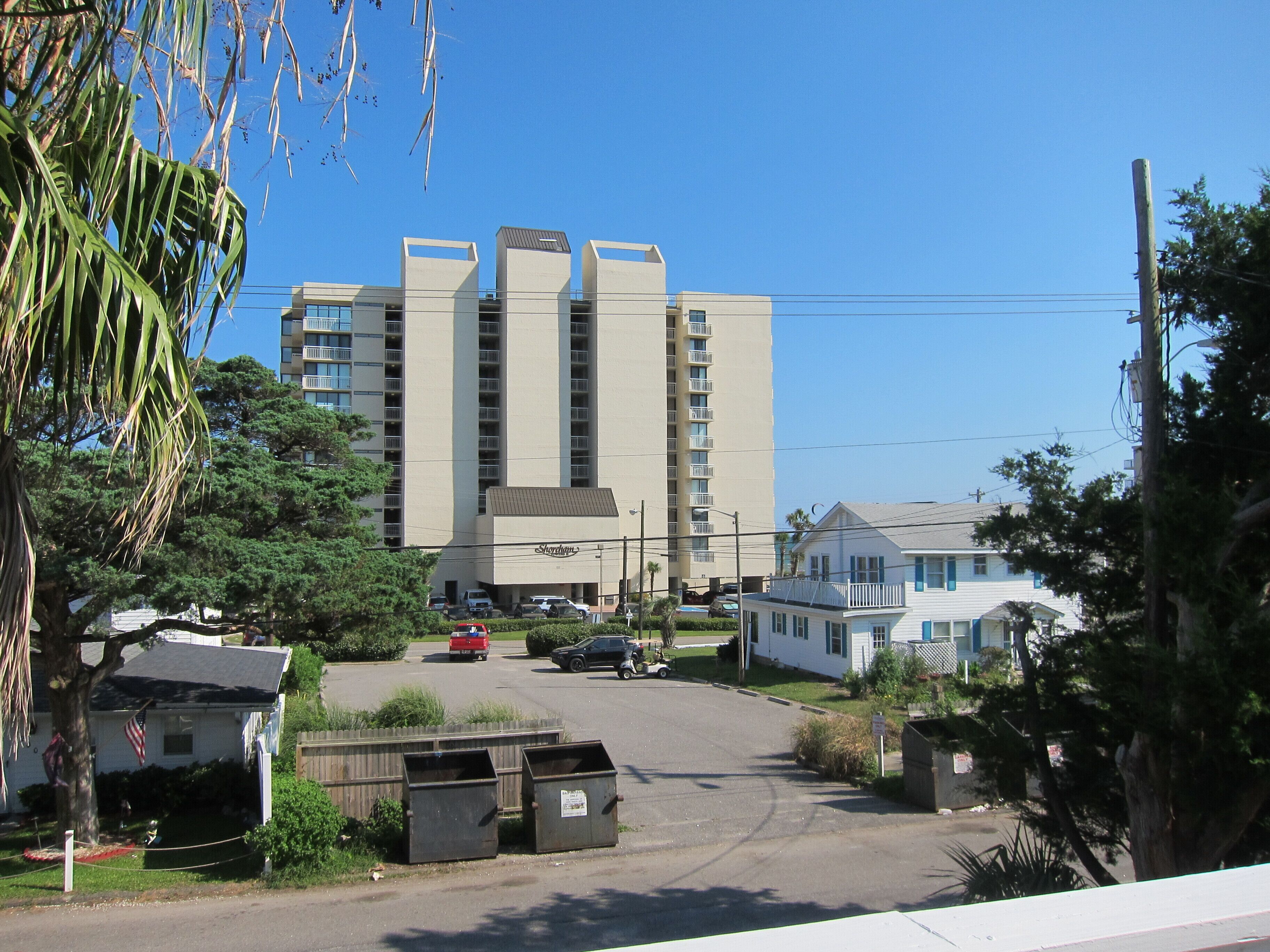 A tall hotel with multiple floors and a central entrance.