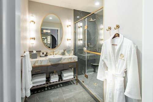Shower, designer toiletries, hair dryer, bathrobes