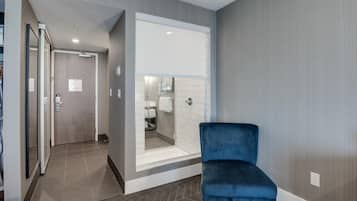 Relax in a spacious room with a large window, plush armchair, and seating area.