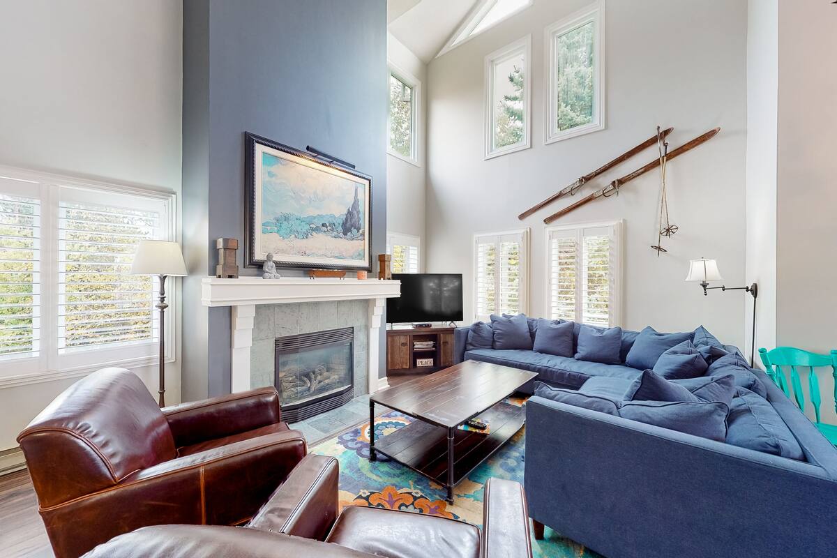 A living room with a fireplace, a television, a sofa, and a coffee table.