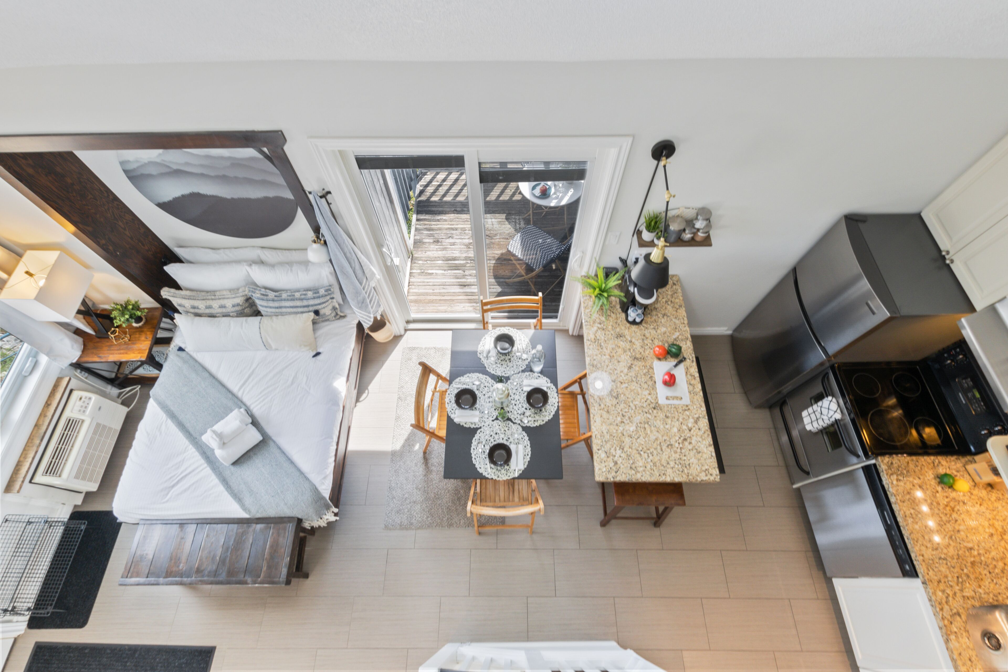 A compact kitchen with a dining area, a built-in stove, and a small seating area.