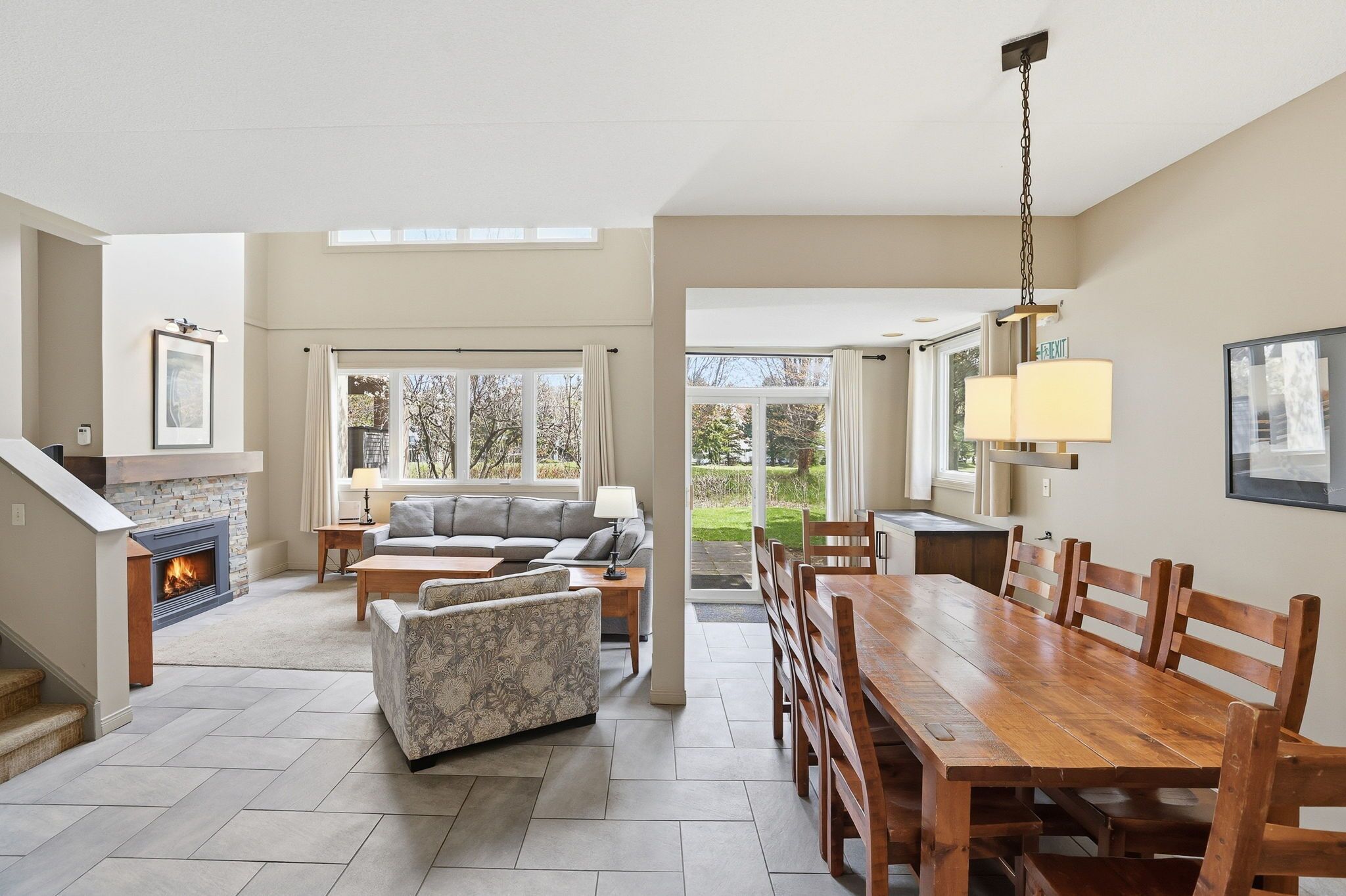 A spacious living area with a fireplace, a dining table, and a sofa.