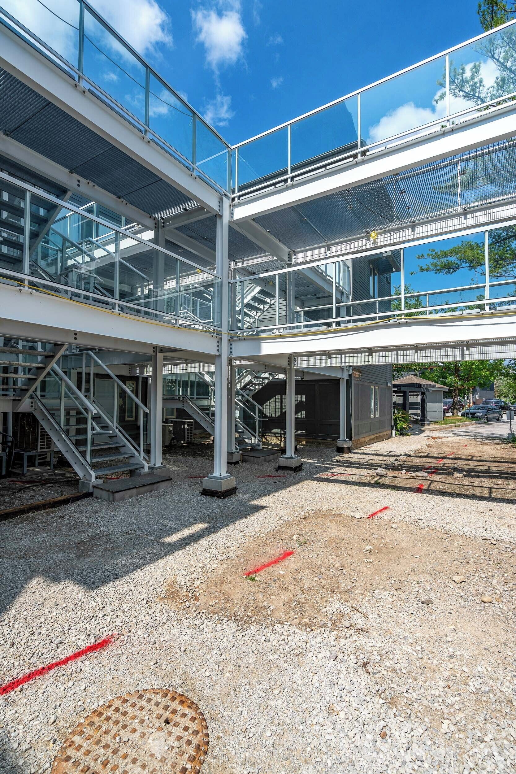 A multi-level commercial building with glass railings and metal staircases.