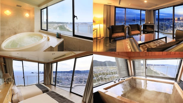 Habitación de hotel con una bañera grande, un sofá y un televisor. La habitación tiene ventanas amplias con vistas a la ciudad.