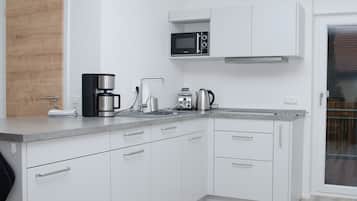 Apartamento Deluxe | Cocina privada | Horno, placa de cocina, cafetera o tetera y tostadora