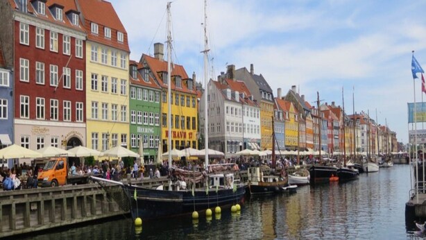 A waterfront with colorful buildings, boats docked along the canal, and people gathered near the water. - Serene Holiday Home in Fanø near Restaurants (Fano)