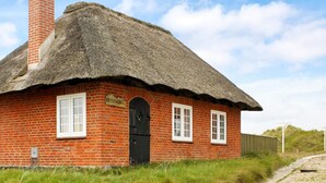 A traditional red brick house with a thatched roof, a chimney, and a sign reading "PEJSEHUSET". - Serene Holiday Home in Fanø near Restaurants (Fano)