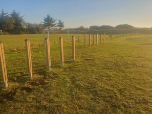 A grassy field with wooden posts and a soccer goal. - 4 Star Holiday Home in Blavand (Blavand)