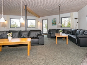 A modern living room with a sofa set, a coffee table, and a lamp. - 30 Person Holiday Home in Nordborg (Nordborg)