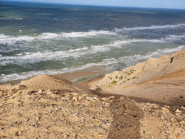 A rocky beach with waves crashing onto the shore.