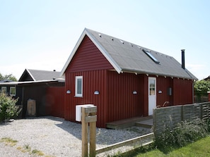 A red building with a sloped roof, a door, and a small window. - 4 Star Holiday Home in Karrebaeksminde (Karrebæksminde)