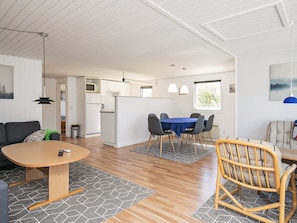 A modern interior with a dining area, kitchen, and living space.