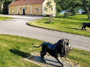 A building with a red roof and a paved driveway leading to it. - Holiday Home in Hova (Hova)