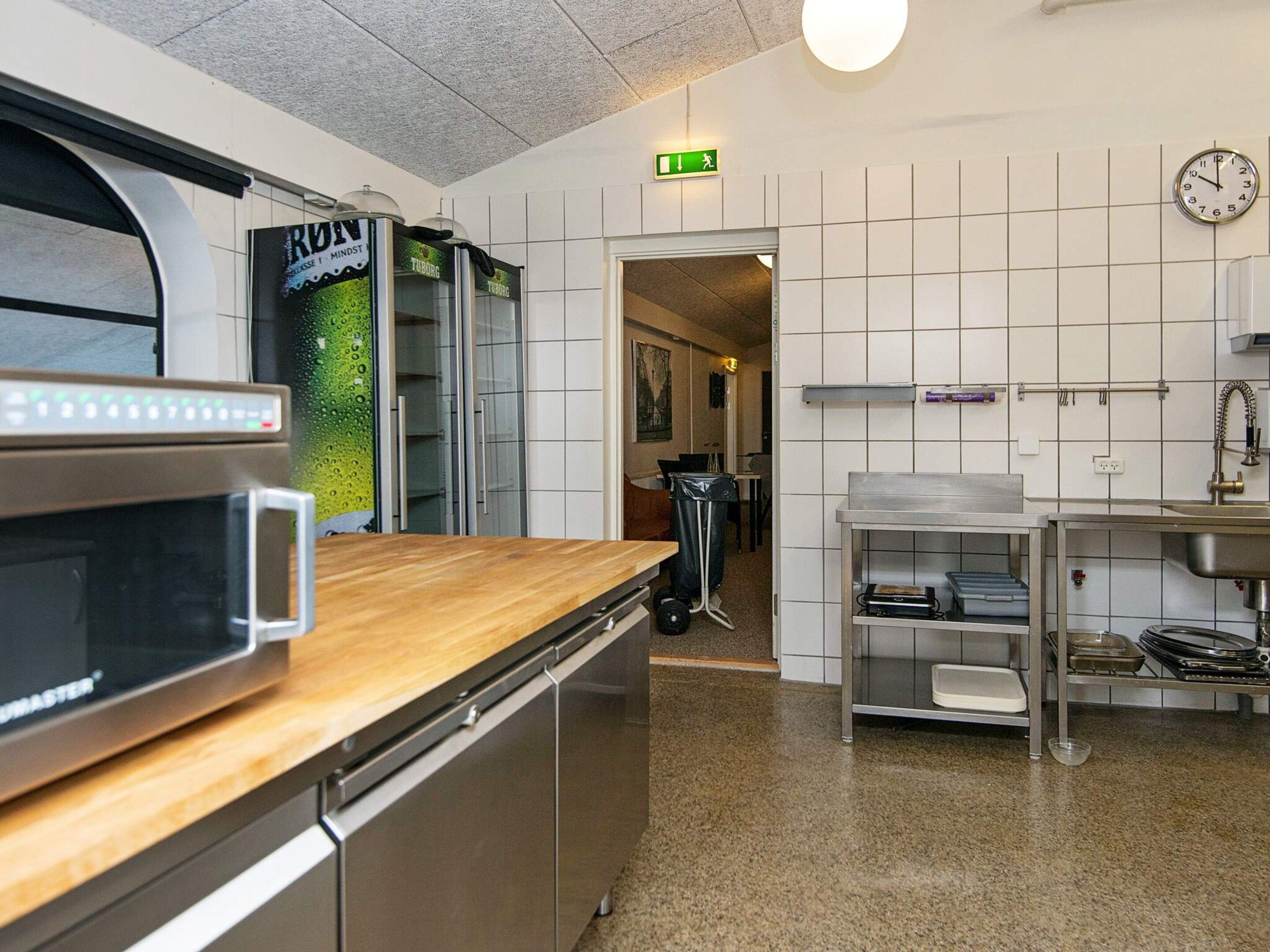 A kitchen with stainless steel appliances, a microwave, and a sink.