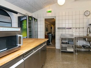 A kitchen with stainless steel appliances, a microwave, and a sink.