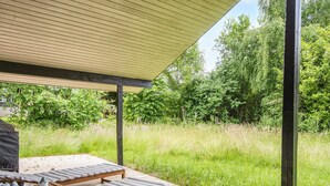 A wooden deck with lounge chairs and a pergola overhead. - 6 Person Holiday Home in Knebel-by Traum (Knebel)
