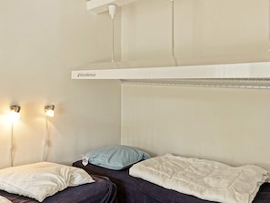 A bedroom with a bunk bed, two bedside lamps, and a headboard labeled 'Wondersun'.
