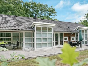 A two-story building with a covered patio area.