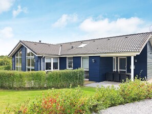 A two-story house with a tiled roof, large windows, and a covered porch area. - 5 Star Holiday Home in Skals (Skals)