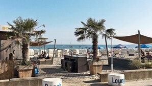 A beachside lounge area with seating and a view of the sea. - Holiday Home in Grossenbrode (Grossenbrode)