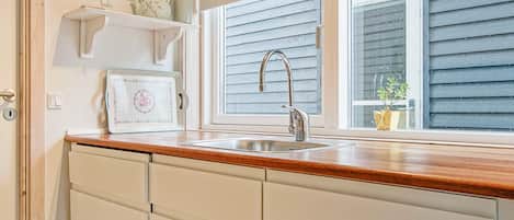 A kitchen with a window, a sink, and a countertop.