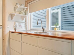 A kitchen with a window, a sink, and a countertop.