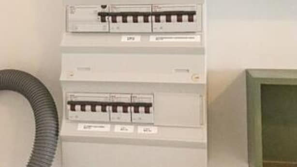 A utility panel with multiple circuit breakers and a flexible conduit. - 4 Person Holiday Home in Gudhjem (Gudhjem)