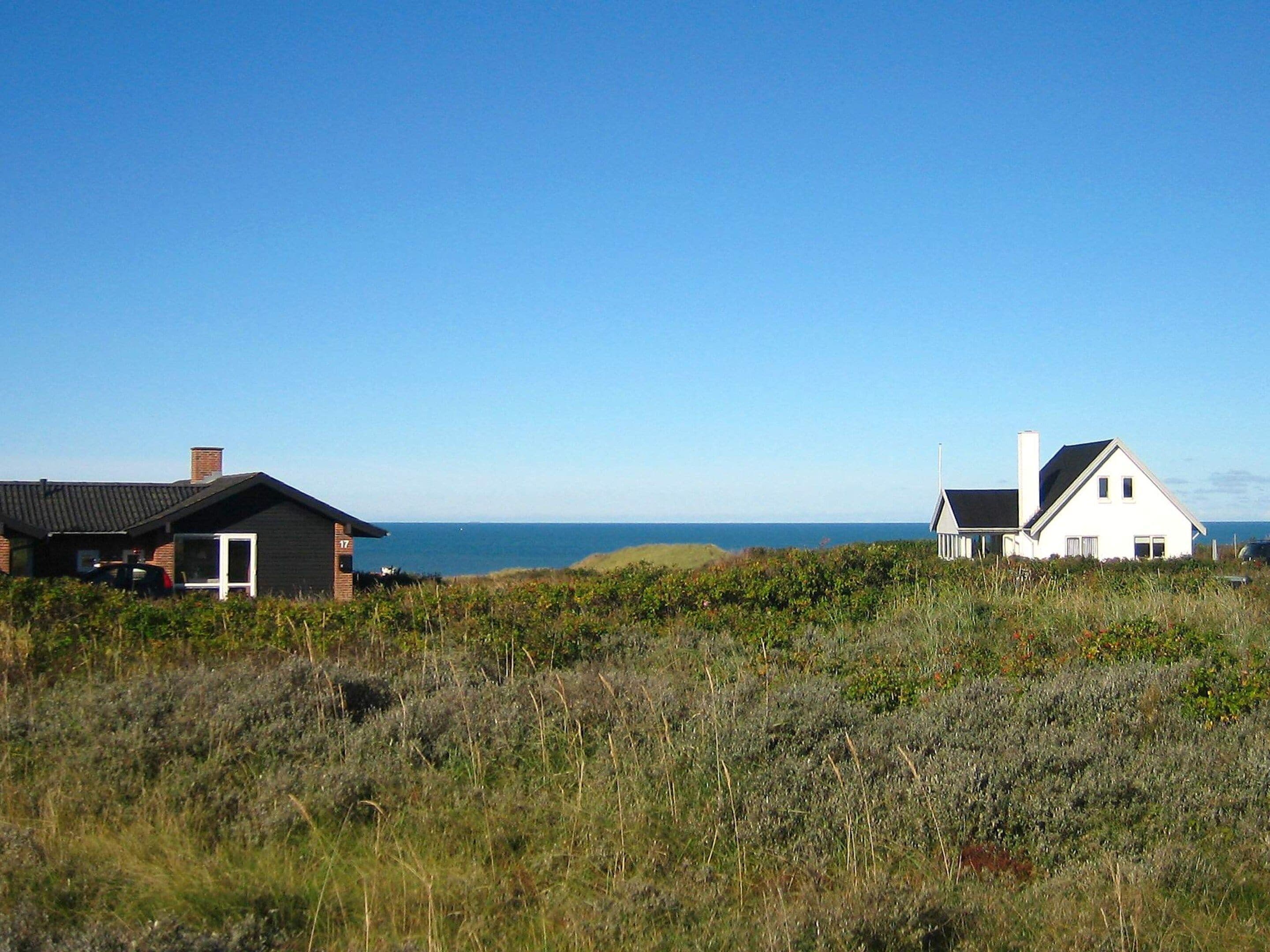 Two houses with a view of the sea.