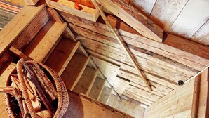 A wooden staircase with a basket of firewood on the left. - Holiday Home in Väddö (Väddö)