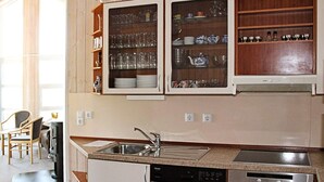 A modern kitchen with a built-in dishwasher, oven, and a microwave above the counter. - Holiday Home in Otterndorf (Otterndorf)