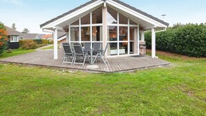 A house with a covered patio, a satellite dish, and a large window. - Holiday Home in Groemitz (Groemitz)
