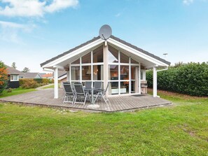 A house with a covered patio, a satellite dish, and a large window. - Holiday Home in Groemitz (Groemitz)