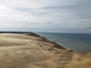 A beach with a sandy shoreline and a view of the ocean.