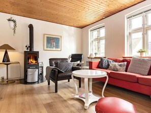 A cozy living room with a fireplace, leather furniture, and large windows. - 6 Person Holiday Home in Marstal (Marstal)