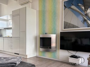 A modern kitchen with white cabinets, a microwave, and a built-in oven. - Holiday Home in Wendtorf (Wendtorf)