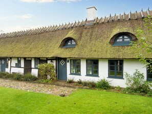 A traditional thatched-roof cottage with a stone pathway leading to the entrance. - 2 Person Holiday Home in Gilleleje (Gilleleje)
