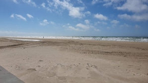 A wide sandy beach with footprints leading to the water, under a partly cloudy sky. - 5 Star Holiday Home in Lokken (Lokken)
