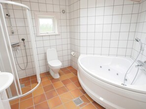 A bathroom with a shower, toilet, and bathtub. - 4 Star Holiday Home in Allinge (Allinge)