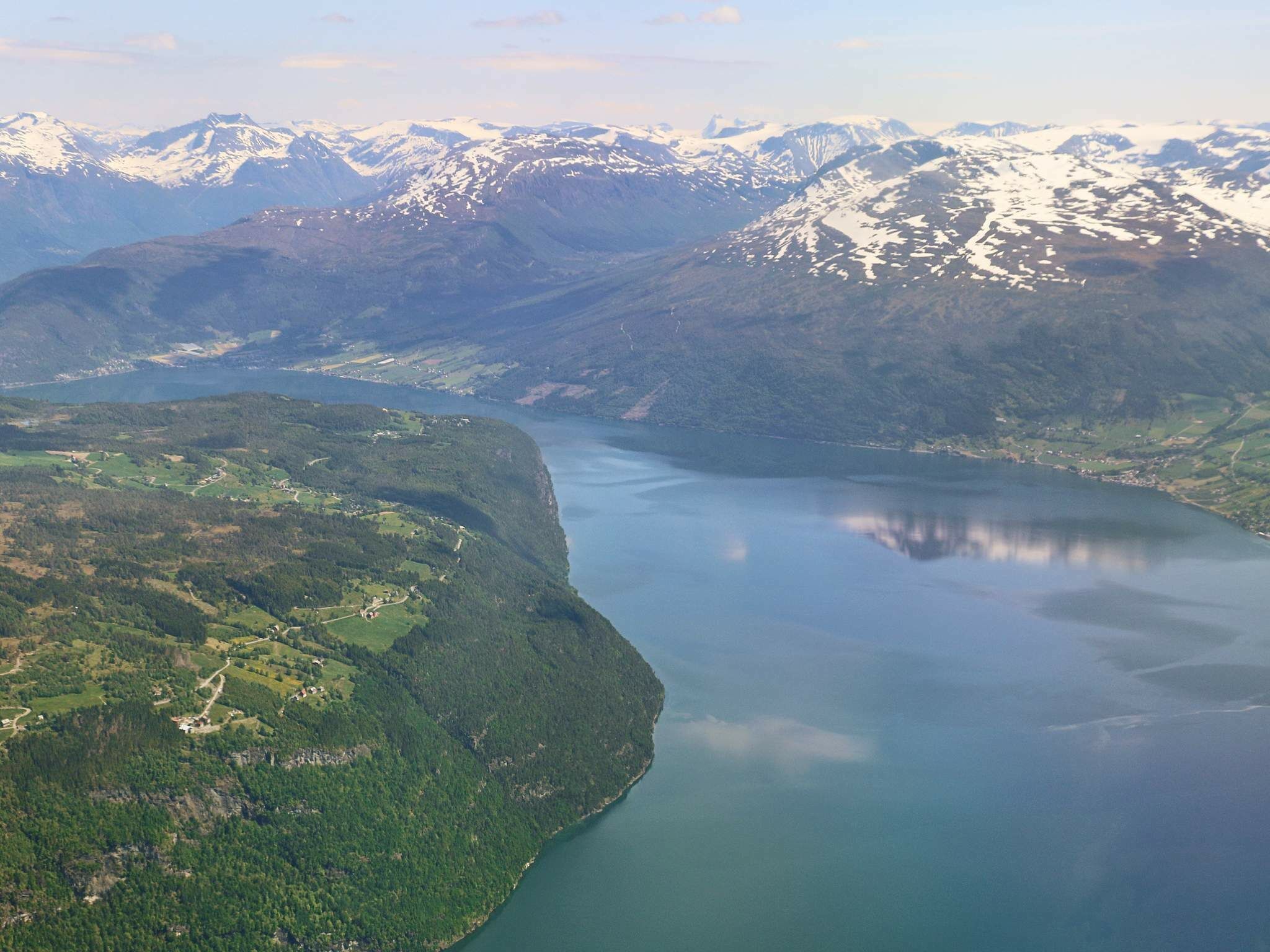 A mountainous landscape with a lake and a small settlement.
