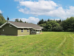 A single-story building with a sloped roof, a small porch, and a satellite dish on the roof. - 6 Person Holiday Home in Bindslev (Bindslev)