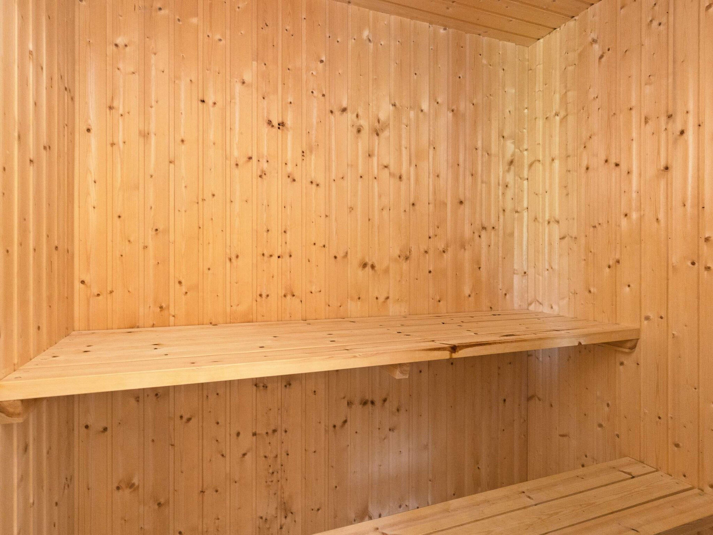 A wooden interior with a wooden bench.