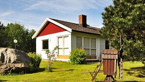 A house with a red roof, a chimney, and a small porch. - 5 Person Holiday Home in Glommen (Glommen)
