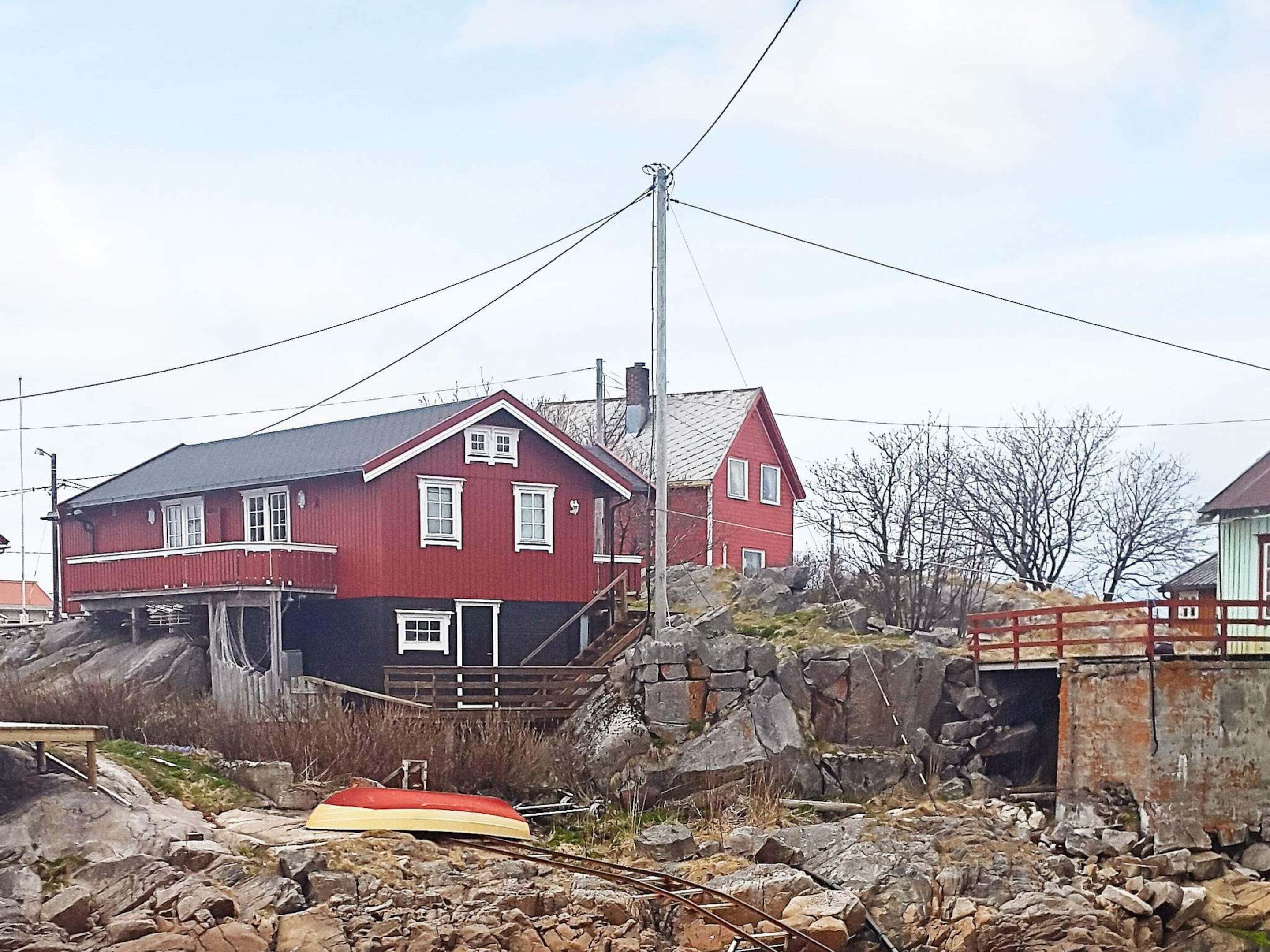 A red building with a steep staircase leading up to a door.
