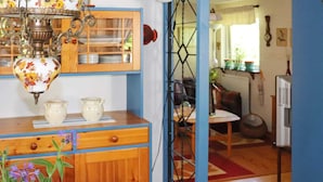 A kitchen with wooden cabinets, a blue-framed window, and a table with a checkered tablecloth. - 3 Person Holiday Home in Hollviken-by Traum (Hollviken)