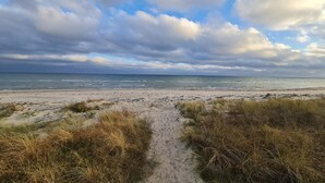 A beach path leading to the ocean with overcast skies. - 4 Star Holiday Home in Vaeggerlose (Vaeggerlose)