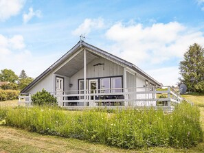 A single-story building with a porch, large windows, and a satellite dish. - 6 Person Holiday Home in Hasle (Hasle)