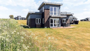 A modern two-story house with a flat roof, large windows, and a balcony. - 8 Person Holiday Home in Faaborg-by Traum (Faaborg)