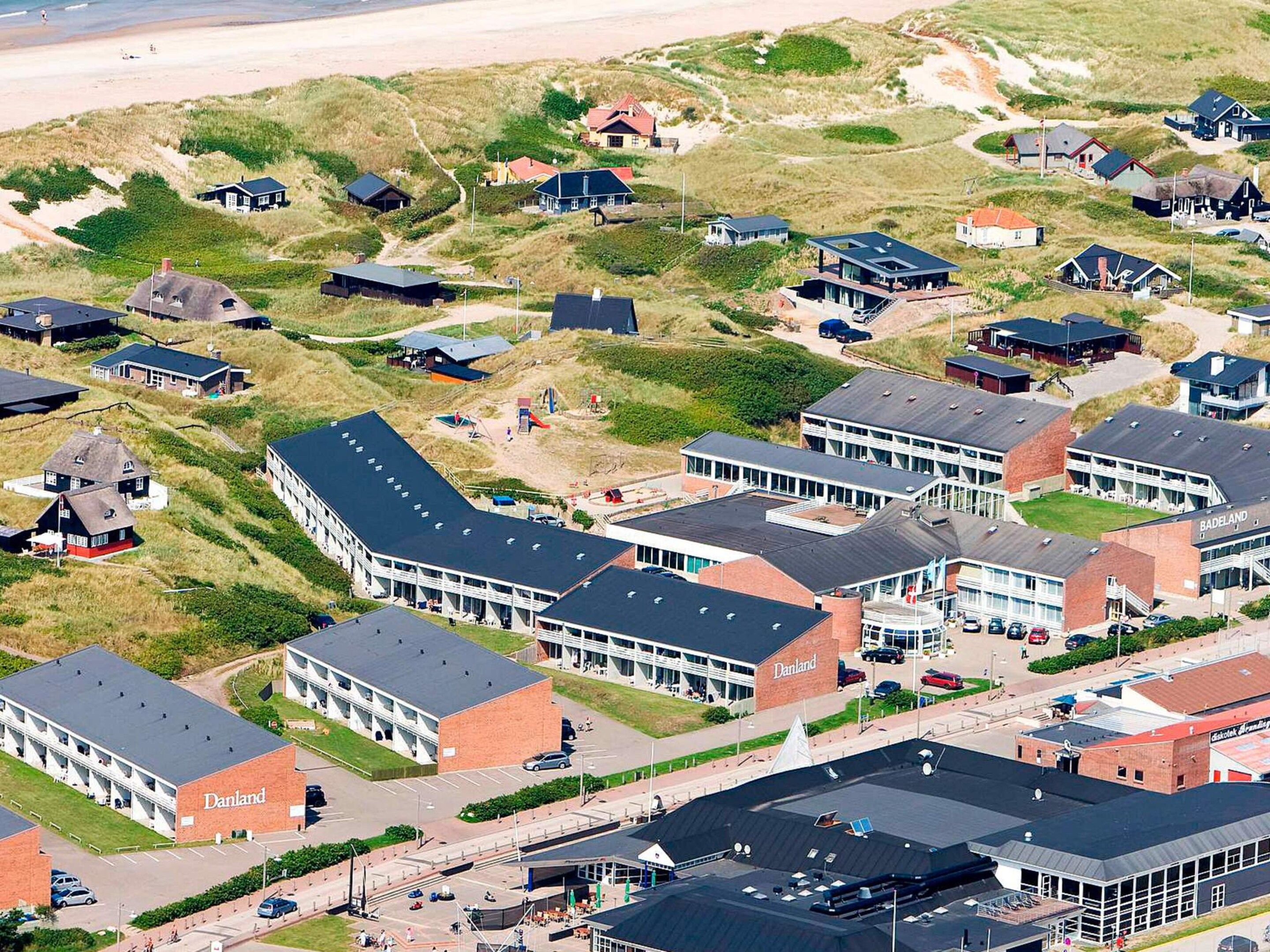 A coastal residential area with modern houses and a large commercial building labeled 'Danland.'