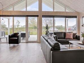 A spacious living area with a large sliding glass door leading to an outdoor patio.